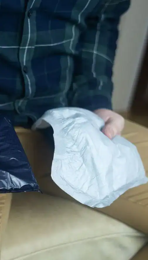 Image of man holding incontinence pads as part of overactive bladder treatment Portsmouth